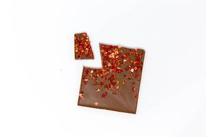 Top View of an organic protein chocolate with strawberry pieces on white background