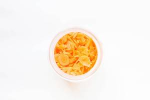 Top view of chopped carrots in jar on white background  Flip 2019