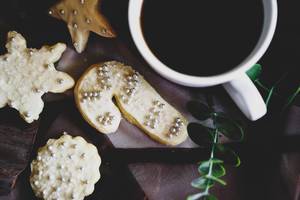 Top view of christmas cookies and a cup of coffee