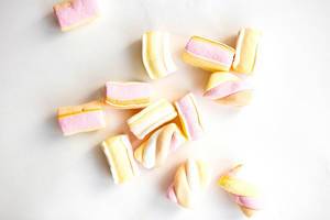 Top view of colorful marshmellows on white background