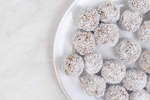 Top view of Energy Balls with Coconut on the plate with copy space