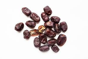 Top view of fresh iranian dates on white background