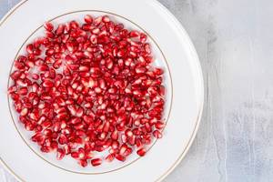 Top view of Fresh Pomegranate on the white plate (Flip 2019)