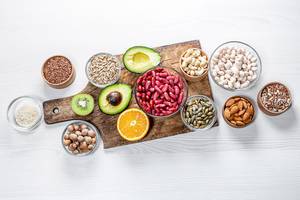 Top view of healthy food components on a white wooden table (Flip 2019)