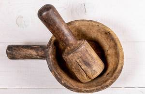 Top view of old wooden mortar and pestle on white wooden background (Flip 2019)