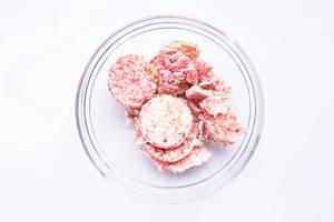 Top view of pink raspberry mini rice cakes in a bowl