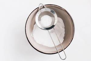 Top view of powdered sugar in a sieve