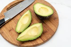 Top view of Sliced fresh Avocado with knife (Flip 2019)