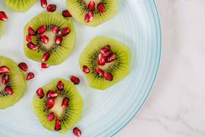 Top view of Sliced Kiwi with Pomegranate (Flip 2019)