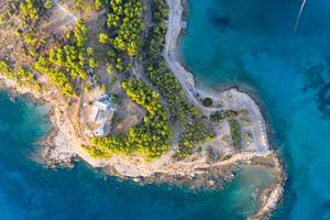 Top view of the island lighthouse of Spetses, on a rocky cliff in the blue Aegean Aea