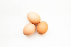 Top view of three eggs on white background  Flip 2019