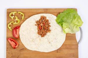 Top view of Tortilla with Minced meat Tomato Lettuce