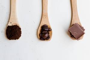 Top View of Wooden Spoons with chocolate and coffee beans
