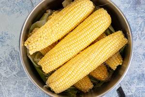 Top view of Young Corn Cobs in the pot ready for cooking