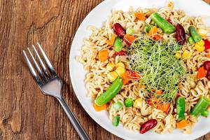 Top view pasta with fresh vegetables and micro greens (Flip 2019)
