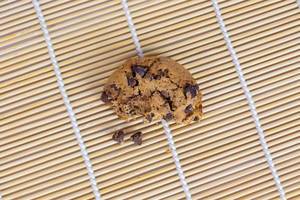 Top View Photo of Half Chocolate Chip Cookie on a Bamboo Mat