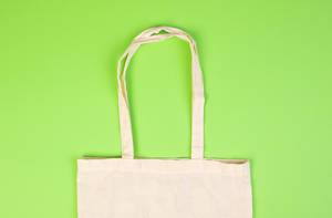 Top View Photo of reusable fabric bag on green Background