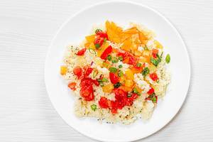 Top view porridge couscous on a white plate with vegetables (Flip 2019)