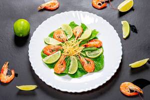 Top view salad with shrimp and slices of line on a black background (Flip 2019)