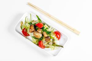 Top view salad with vegetables and mushrooms on a white background with chopsticks