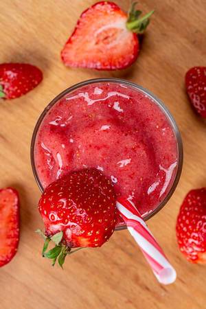 Top view, strawberry smoothie on a wooden background