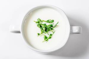 Top view white mushroom soup with micro greenery in tureen (Flip 2019)