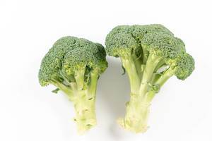 Topv view of Fresh Broccoli above white background (Flip 2020)
