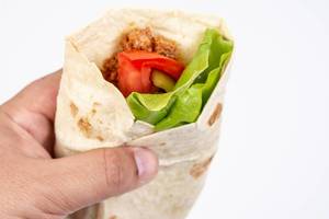 Tortilla with Minced meat Tomato and Lettuce in the hand