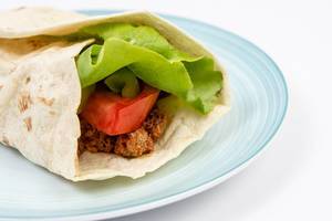 Tortilla with Minced meat Tomato Lettuce served on the plate (Flip 2019)