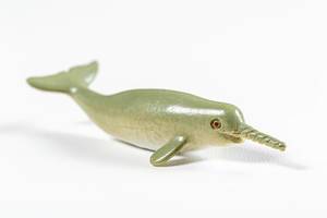 Toy whale narwhal on a white background