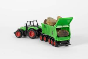 Tractor and wagon loaded with rocks