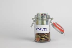 Travel money savings in a glass jar