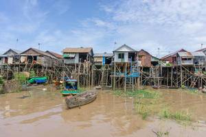 Travel Photo of Local Houses with Wooden Boats near Tonle Sap Lake in Siem Reap, Cambodia