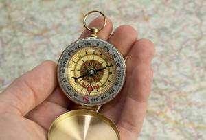 Traveler holding compass in hand