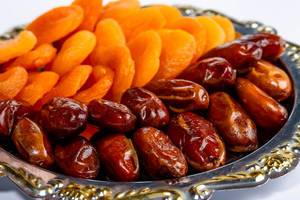 Tray with dried dates and dried apricots close-up (Flip 2019)