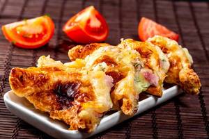 Triangle-cut fried khachapuri with cheese and meat