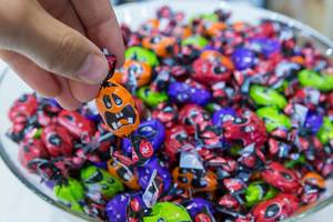Trick or treat? A plate of funny, multicolored Halloween sweets
