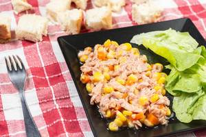 Tuna Fish with Corn and green Salad on the table