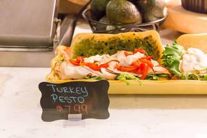 Turkey pesto sandwich: smoked turkey breast, pesto, green salad, pepper and cream cheese