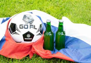 Two beer bottles with soccer ball on Russian flag