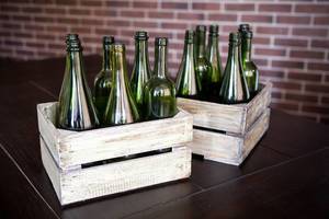 Two boxes of green wine bottles