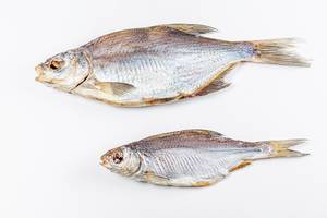 Two dried fish on a white background, top view