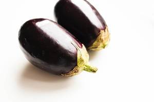 Two eggplants on white background