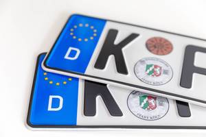 Two German license plates of the city Cologne - North Rhine-Westphalia, with white background