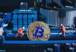 Two miners and Bitcoin on a Mother board