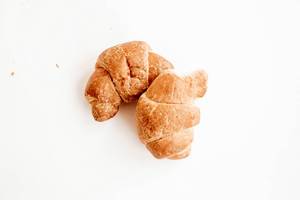 Two mini croissants on white background