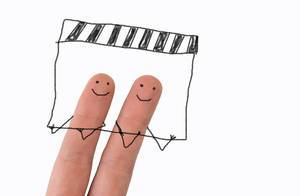 Two painted happy fingers with movie clapper