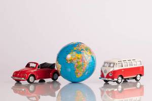 Two red classic cars with globe