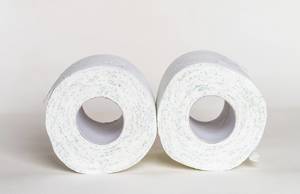 Two toilet paper rolls on the floor