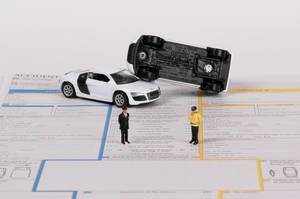 Two toy cars on accident statement report